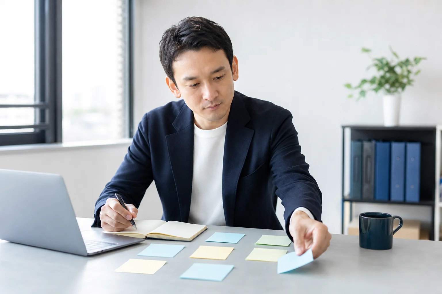 パソコンやノートと付箋を使いITの困りごとを整理する小規模事業者